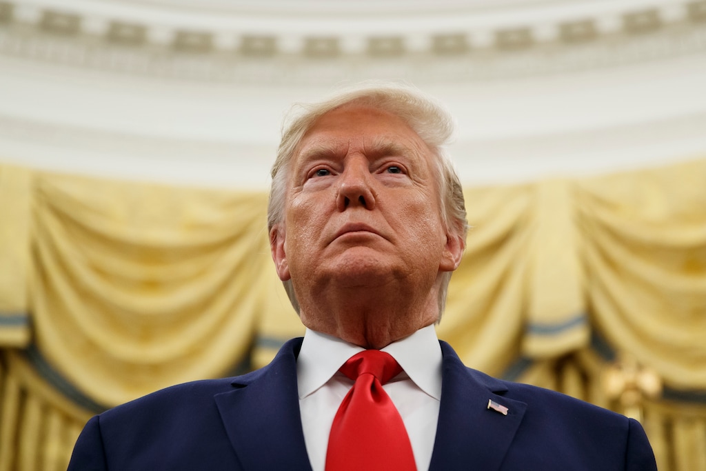 (Alex Brandon | AP file photo) President Donald Trump stands during a Presidential Medal of Freedom ceremony for auto racing great Roger Penske in the Oval Office of the White House, Thursday, Oct. 24, 2019, in Washington.