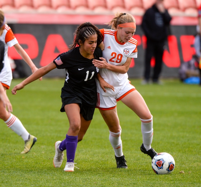 (Chris Samuels | The Salt Lake Tribune) Skyridge’s Olivia Barlow (29) jostles with Riverton’s Mari Regla (11) in the 6A girls’ soccer state championships at Rio Tinto Stadium in Sandy, Friday, Oct. 22, 2021.