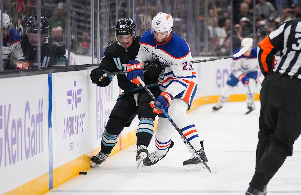 (Bethany Baker  |  The Salt Lake Tribune) Utah Hockey Club center Barrett Hayton (27) and Edmonton Oilers defenseman Darnell Nurse (25) vie for the puck at the Delta Center in Salt Lake City on Friday, Nov. 29, 2024.