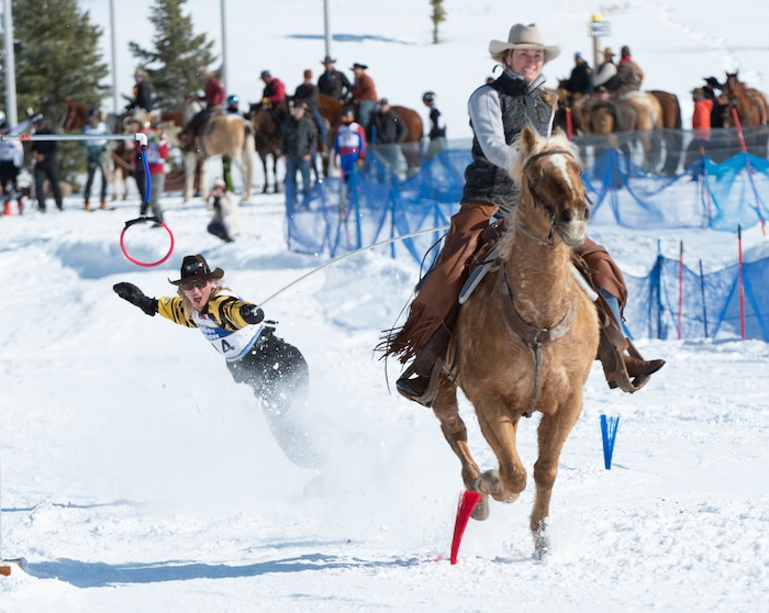(Rick Egan | The Salt Lake Tribune) JP Fleege rides a snowboard, as he is pulled by Hannah Peterson, riding Dandy the horse, in the first day of the Skijoring competition at Soldier Hollow Friday. Feb. 22, 2019. The competition continues on Saturday.