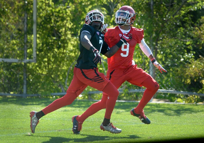 Scott Sommerdorf | The Salt Lake Tribune
WR Darren Carrington II looks back for the ball as he battles with DB Jaylon Johnson during the first day of Utah fall football camp, Friday, July 28, 2017.