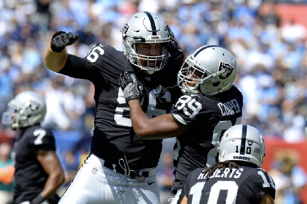 Oakland Raiders wide receiver Amari Cooper (89) celebrates with Lee Smith (86) after Cooper scored a touchdown on an 8-yard pass against the Tennessee Titans in the first half of an NFL football game Sunday, Sept. 10, 2017, in Nashville, Tenn. AP Photo| Mark Zaleski.