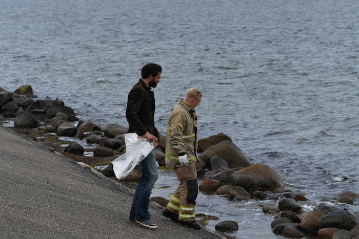 Police officers attend the south coast of the isle of Amager, near Copenhagen, Denmark, Monday Aug. 21, 2017. The body of a woman has been found in the Baltic Sea near where a missing Swedish journalist is believed to have died on a privately built submarine, police in Denmark said late Monday. (Kenneth Meyer/Ritzau Foto via AP)