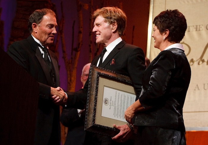 (Leah Hogsten | The Salt Lake Tribune) Gov. Gary Herbert, left, and his wife Jeanette present Robert Redford with a declaration as he is recognized and honored by at a gala in his honor, "The Governor's Salute to Robert Redford: A Utah Tribute to an American Icon" at the Grand America Hotel, Saturday, Nov. 9, 2013.
