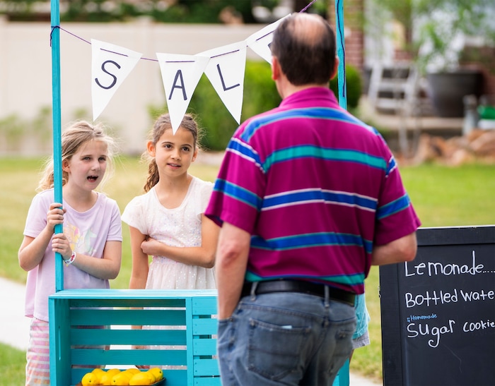 (Rick Egan | The Salt Lake Tribune)  Lucy Haslam and Penelope Vasquez Pitcher sell lemonade at the Heart & Soul Music Stroll, in Sugar House, on Saturday, June 10, 2023.