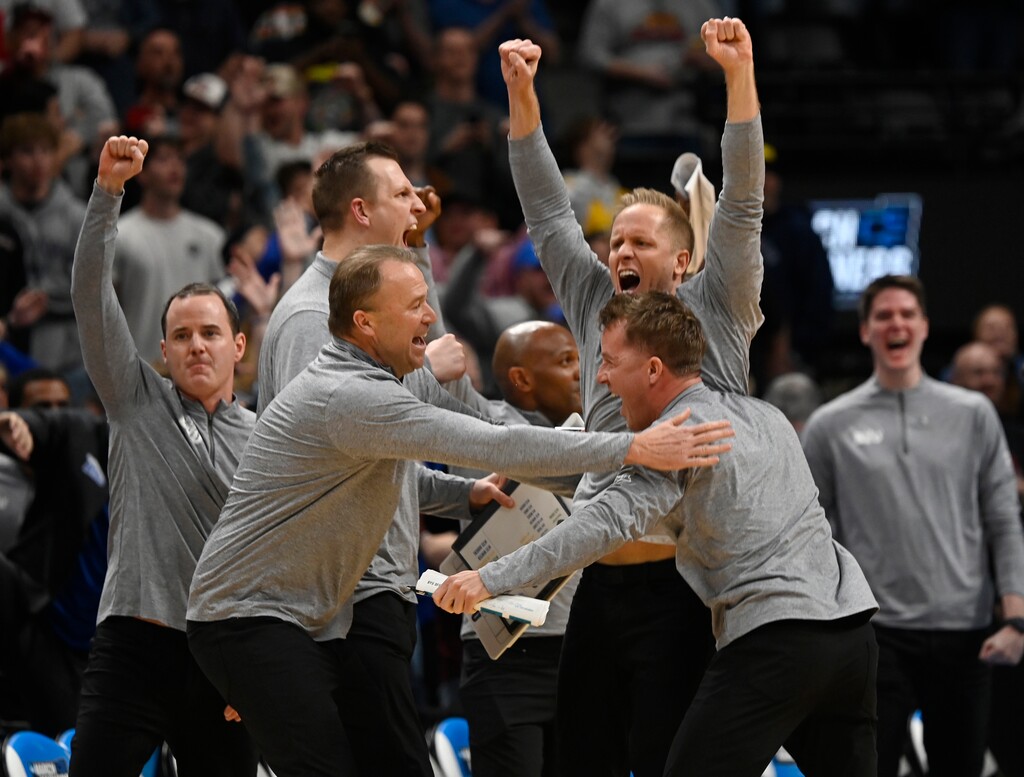 (John Leyba | AP) BYU head coach Kevin Young, top right, celebrates as time runs out in the second half against Wisconsin in the second round of the NCAA college basketball tournament Saturday, March 22, 2025, in Denver.