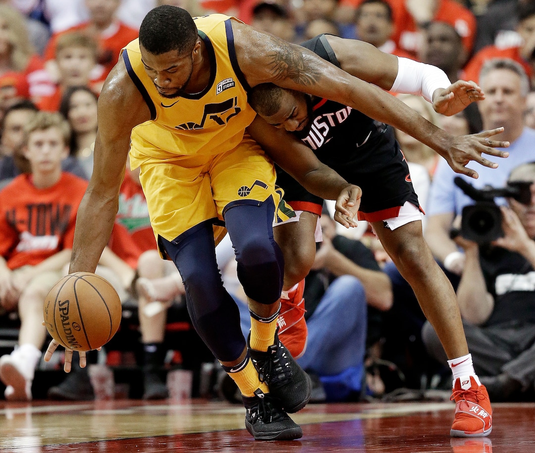 Utah Jazz forward Derrick Favors, left, and Houston Rockets guard Chris Paul chase the ball during the second half in Game 1 of an NBA basketball second-round playoff series Sunday, April 29, 2018, in Houston. (AP Photo/Eric Christian Smith)