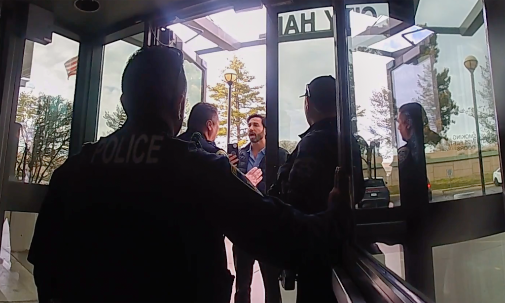 (South Salt Lake Police) Footage from a body camera shows South Salt Lake City Council member Paul Sanchez attempting to enter City Hall on March 13, 2024. Sanchez received a censure from the council and was barred from attending council meetings in person. He was arrested as a result.