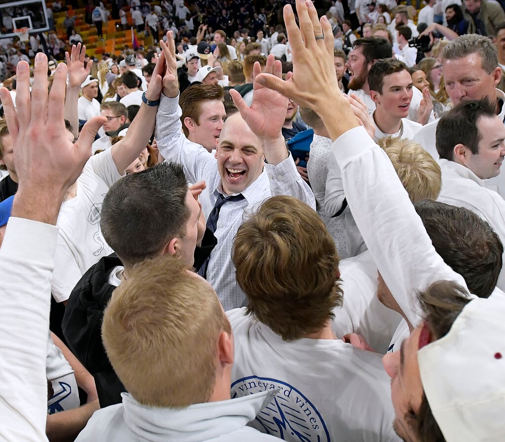 (Eli Lucero  |  The Herald Journal via AP) Utah State coach Craig Smith celebrates with fans on the court after Utah State defeated No. 12 Nevada 81-76 in an NCAA college  basketball game Saturday, March 2, 2019, in Logan, Utah.