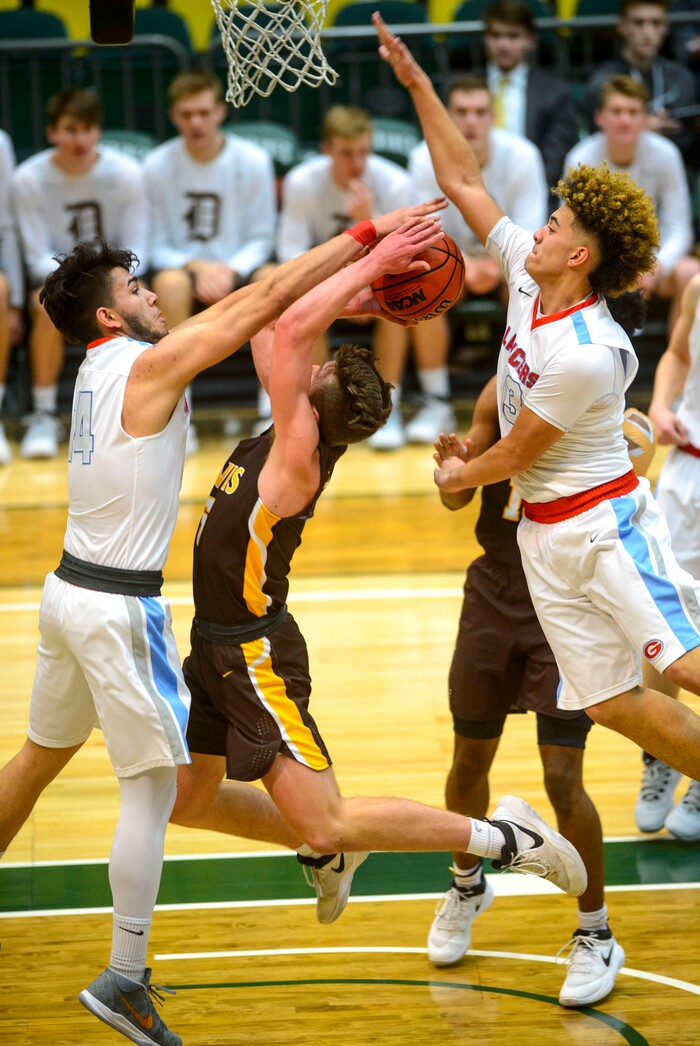 (Steve Griffin  |  The Salt Lake Tribune) Davis guard Josh Sanders gets stopped at the basket by Granger's Jason Murillo and Jarom Unga during their 6A basketball playoff game at Utah Valley UniversityÕs UCCU Center in Provo Tuesday Feb. 27, 2018.