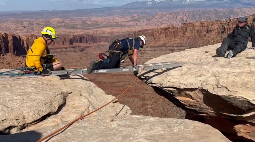 (Photos courtesy of Grand County EMS) Grand County EMT Allison Jensen tends to an injured man stranded on a hoodoo at Pucker Pass in Long Canyon on Saturday, May 5.
