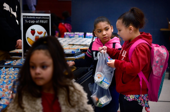 Scott Sommerdorf | The Salt Lake TribuneTatiana Lopez, right, helps her friend Crystal make choices as they go through lines in the cafeteria at Backman Elementary SchoolÕs Breakfast in the Classroom program, Wednesday, March 21, 2018.