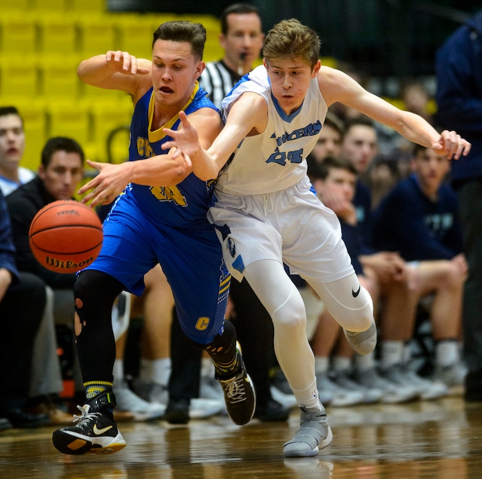 (Steve Griffin  |  The Salt Lake Tribune) Cyprus guard  Skyler Case battles Layton's Chase Potter for a loose ball during 6A basketball playoff game at the Utah Valley UniversityÕs UCCU Center in Provo Tuesday Feb. 27, 2018.