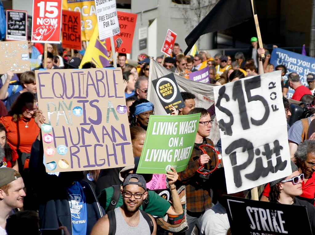 FILE - In this April 14, 2016, file photo, union organizers, students, and supporters for a $15 an hour wage march through the Oakland section Pittsburgh. The job market has changed under President Barack Obama's 8 years. IT and engineering, scientific research jobs have grown strongly; restaurant, hotel jobs on lower end as well. (AP Photo/Keith Srakocic, File)