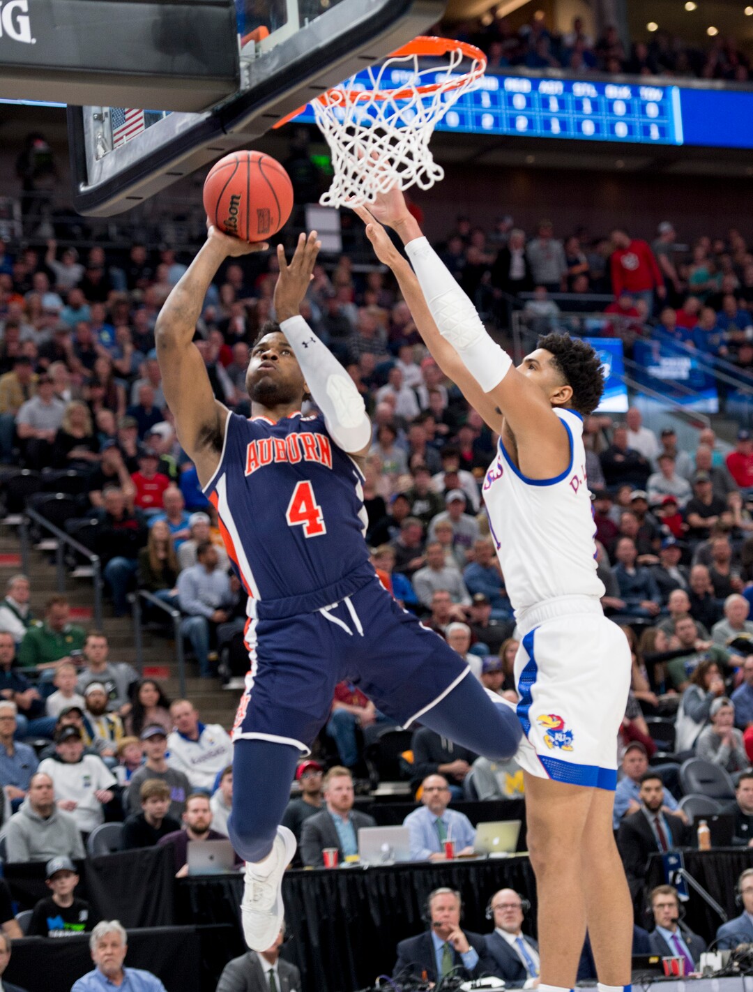 (Leah Hogsten  | The Salt Lake Tribune)  Auburn Tigers guard Malik Dunbar (4) shoots past Kansas Jayhawks forward Dedric Lawson (1) as Auburn faces Kansas in the second round of the NCAA tournament in Salt Lake City on Saturday, March 23, 2019.