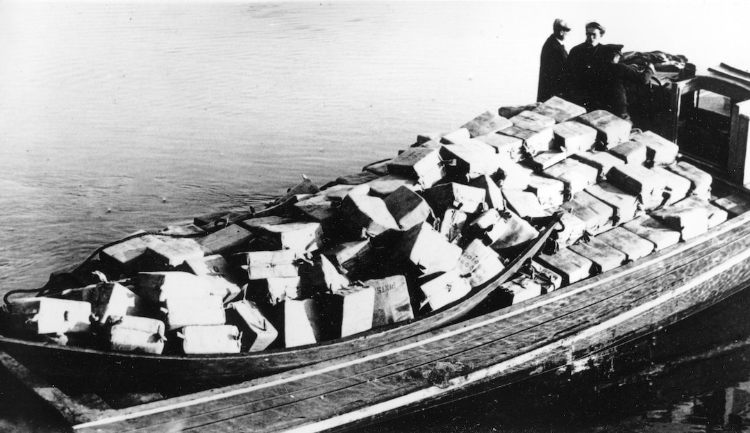 FILE - In this May 6, 1932, file photo coast guardsmen stand on a speed boat packed with nearly 700 cases of liquor they captured as it was unloaded at Newburyport, Mass. They pursued the craft from outside the harbor into the Merrimack River. The crew fled as the government boat approached. (AP Photo, File)