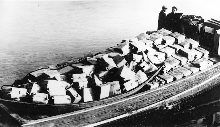 FILE - In this May 6, 1932, file photo coast guardsmen stand on a speed boat packed with nearly 700 cases of liquor they captured as it was unloaded at Newburyport, Mass. They pursued the craft from outside the harbor into the Merrimack River. The crew fled as the government boat approached. (AP Photo, File)
