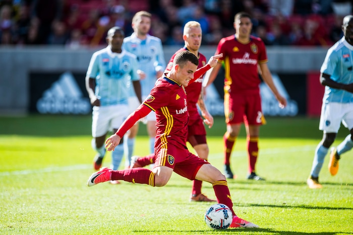 (Chris Detrick  |  The Salt Lake Tribune)  Real Salt Lake forward Brooks Lennon (27) scores a goal past Sporting Kansas City goalkeeper Andrew Dykstra (21) during the game at Rio Tinto Stadium Sunday, October 22, 2017.  