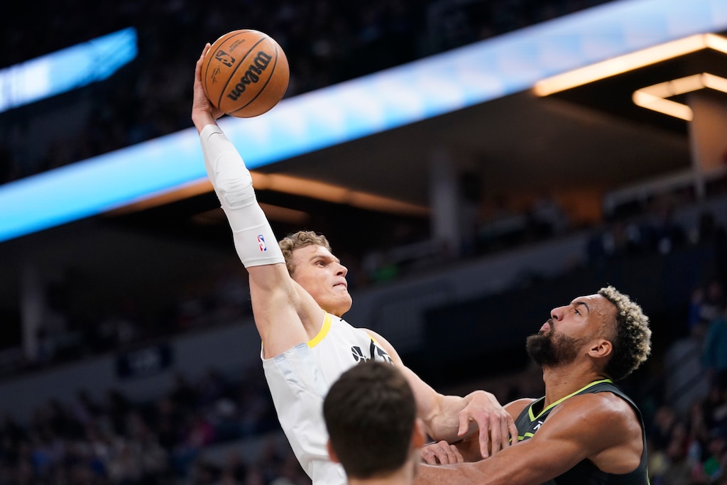 Utah Jazz forward Lauri Markkanen goes up for a dunk over Minnesota Timberwolves center Rudy Gobert, right, during the first half of an NBA basketball game Friday, Oct. 21, 2022, in Minneapolis. (AP Photo/Abbie Parr)