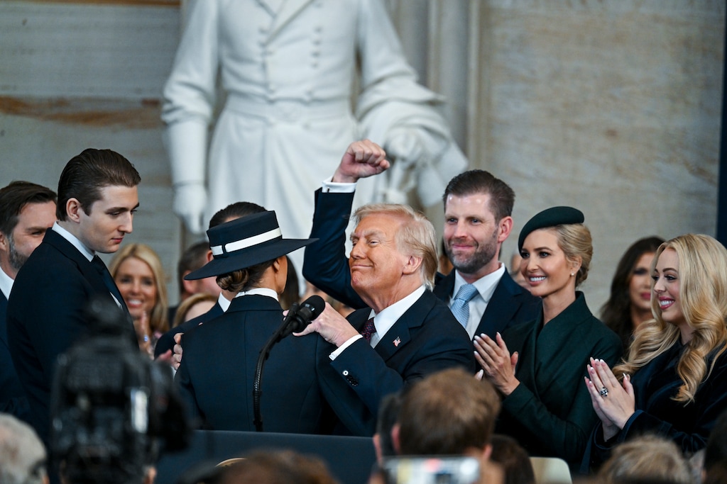 (Kenny Holston | The New York Times) President Donald Trump pumps his fist and is surrounded by his family after he was sworn in by Supreme Court Chief Justice John Roberts during his inauguration ceremony as the 47th president in the Rotunda at the Capitol in Washington on Monday morning, Jan. 20, 2025.