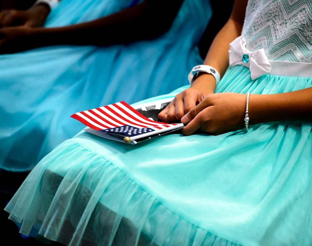 (Steve Griffin | The Salt Lake Tribune) Linh Tran, age 10, holds holds the American Flag as several children, ages 7 to 14, received citizenship certificates from the Salt Lake County and U.S. Citizenship and Immigration Services during the ceremony in Salt Lake City Monday August 7, 2017.