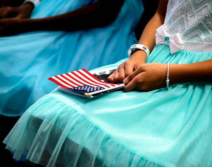 (Steve Griffin | The Salt Lake Tribune) Linh Tran, age 10, holds holds the American Flag as several children, ages 7 to 14, received citizenship certificates from the Salt Lake County and U.S. Citizenship and Immigration Services during the ceremony in Salt Lake City Monday August 7, 2017.