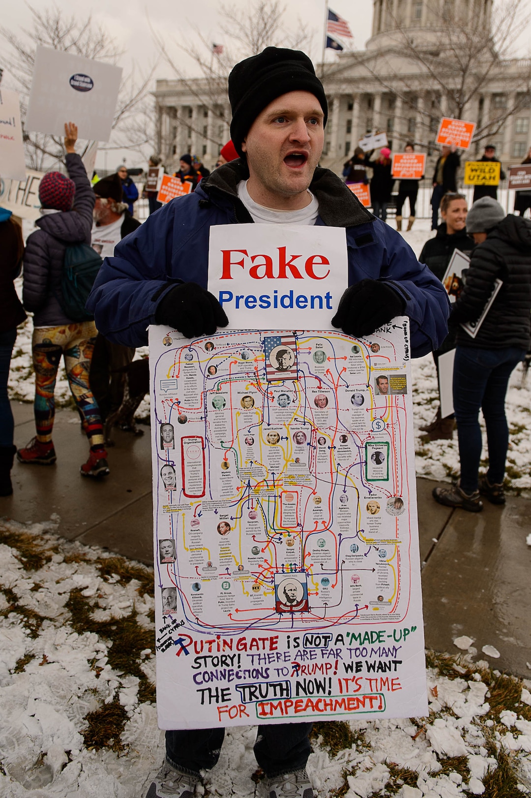 (Trent Nelson | The Salt Lake Tribune)  Don Thorpe holds a sign as protesters gather before a visit by President Donald Trump, Monday December 4, 2017.