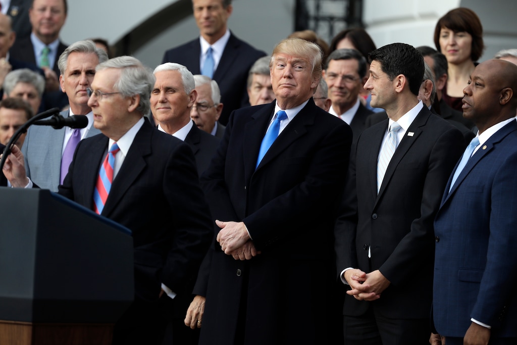 Senate Majority leader Mitch McConnell of Ky., speaks as President Donald Trump, House Speaker Paul Ryan of Wis., and Sen. Tim Scott, R-S.C., right, listen during a bill passage event on the South Lawn of the White House in Washington, Wednesday, Dec. 20, 2017, to acknowledge the final passage of tax cut legislation by Congress. (AP Photo/Evan Vucci)