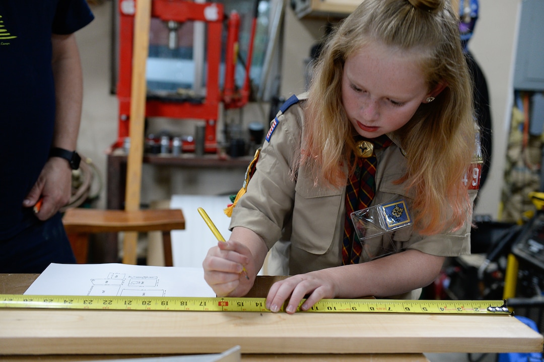 (Francisco Kjolseth  |  The Salt Lake Tribune)  Miriam Cook, an early adopter into Cub Scouts, spends time helping her older brother with his Eagle Scout project in the family garage in Tooele, Monday, May 15, 2018. Currently in Webelo's, Miriam has a goal of getting her Eagle of Light badge and becoming a part of a girl's scout troop after the crossover in 2019. 