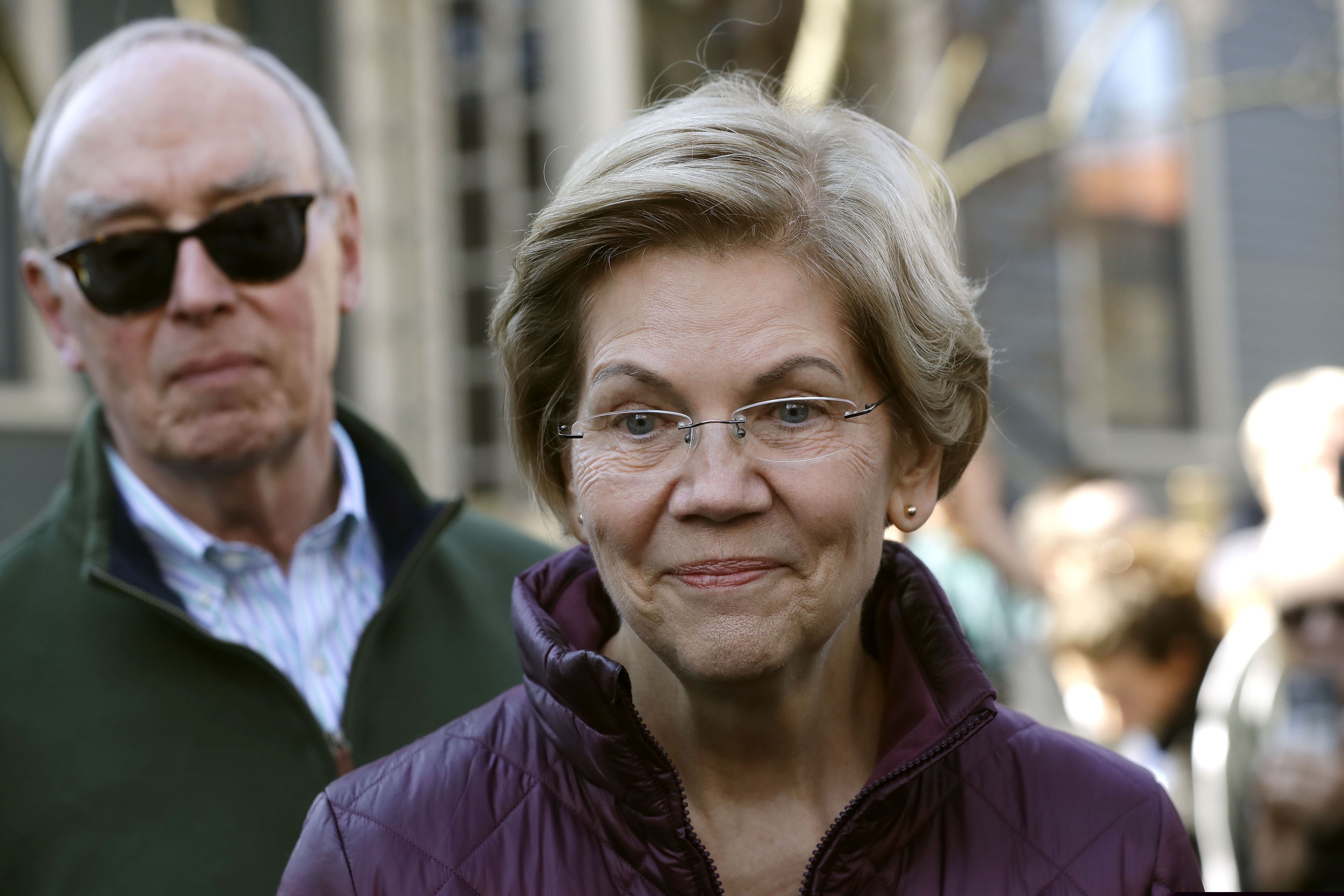 (Steven Senne | AP) Sen. Elizabeth Warren, D-Mass., speaks outside her home beside her husband Bruce Mann, Thursday, March 5, 2020, in Cambridge, Mass., after she dropped out of the Democratic presidential race.