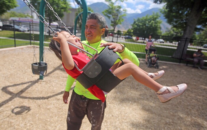 Romulo Gonzalez Rodriguez plays with his 3-year-old daughter Genesis following a interview Tuesday, June 19, 2018, in Provo, Utah. Romulo Gonzalez Rodriguez remembers the anguish of being separated from his 3-year-old daughter, Genesis Gonzalez Lopez, for seven days in November after arriving to the U.S. port of entry in San Diego. Romulo Gonzalez Rodriguez said he fled his hometown of Champerico, Guatemala to seek asylum in the United States after he was kidnapped and extorted by captors who cut his eye out and nearly killed him. (AP Photo/Rick Bowmer)