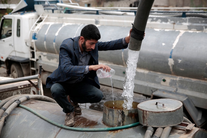 In this photo taken on Wednesday, Jul. 26, 2017, a man adds chlorine solution as he fills a tanker truck with water from a water tap in Sanaa, Yemen. Yemen’s raging two-year conflict has served as an incubator for lethal cholera. (AP Photo/Hani Mohammed)