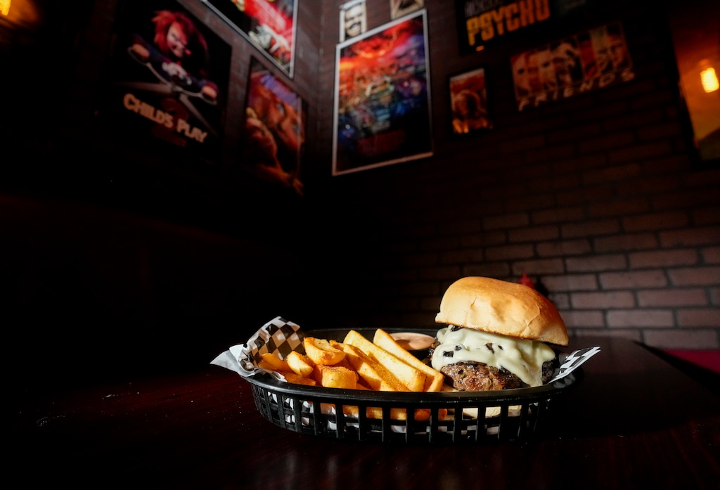 (Bethany Baker  |  The Salt Lake Tribune) The 'Exorswiss and Mushrooms' burger sits on a table at Burgertory SLC, a horror-themed restaurant, in West Valley City on Friday, June 21, 2024.