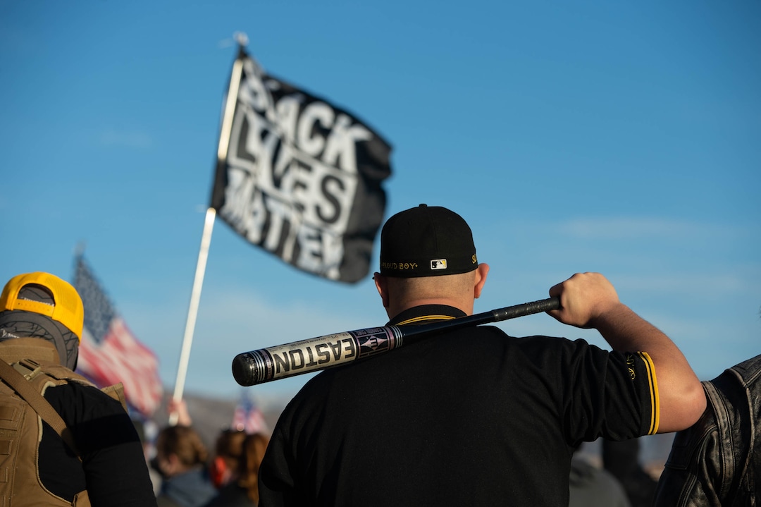 (Francisco Kjolseth  | The Salt Lake Tribune) A member of the Proud Boys carries a bat as they pressure a small group carrying a Black Lives Matter Flag at a pro-Trump rally at the Utah State Capitol in Salt Lake City on Wednesday, Jan. 6, 2021.
