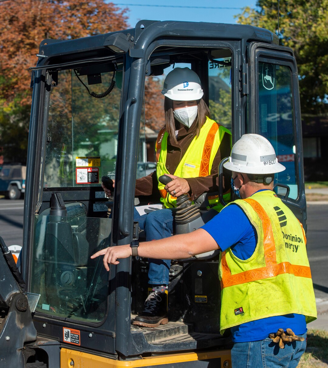 (Rick Egan  |  The Salt Lake Tribune)   Salt Lake City Mayor Erin Mendenhall digs a hole for a tree using a mini excavator with the assistance of Chase Bybee, as she joins more than 100 volunteers from Dominion Energy to plant 205 trees in the Fairpark neighborhood, which is said to be single largest volunteer tree planting event in Salt Lake City, on Thursday, Oct. 1, 2020.