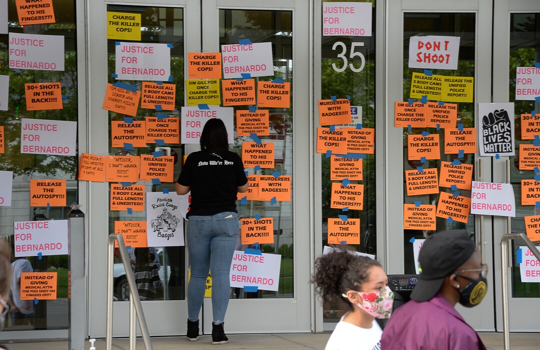 (Francisco Kjolseth  |  The Salt Lake Tribune) A group of about twenty people again showed up at the Salt Lake County District AttorneyÕs Office on Sunday, June 21, 2020, as part of their vow to come out every day until officials release the investigation into Bernardo Palacios-CarbajalÕs death by police. They hung protest signs on the building's windows.