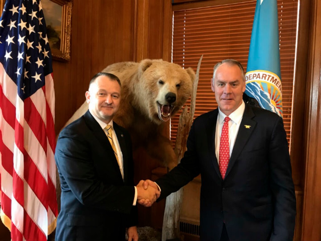 (National Park Service via AP) This undated photo provided by the National Park Service shows Secretary of the Interior Ryan Zinke, right, congratulates Cameron "Cam" Sholly who was named the new superintendent to Yellowstone National Park, on Wednesday, June 13, 2018 in Washington.