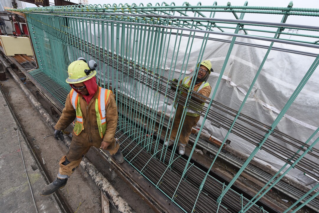 (Francisco Kjolseth  |  The Salt Lake Tribune)  Crew members Meli Kaufausi, left, and Simone Katoa work on the extensive structural integrity of a bridge beam at Forterra Structural Precast in Kearns on Tuesday, Dec. 11, 2018. UDOT is in the process of placing some of the world's largest-ever bridge beams, with the same design,  along the technology corridor in Lehi later this week.