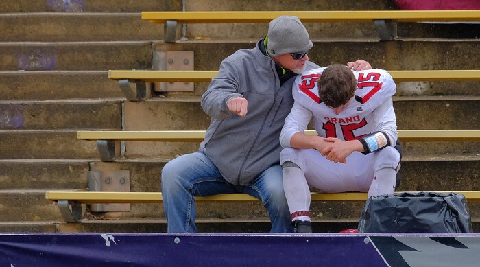 (Leah Hogsten  |  The Salt Lake Tribune)  Grand County's Bryant Troutt gets a little pep talk in the stands after he was ejected from the game for unsportsmanlike conduct.   South Summit High School boys' football team defeated Grand County High School 47-9 during their class 2A state semifinal football game Saturday, November 4, 2017 at Weber State University's Stewart Stadium.