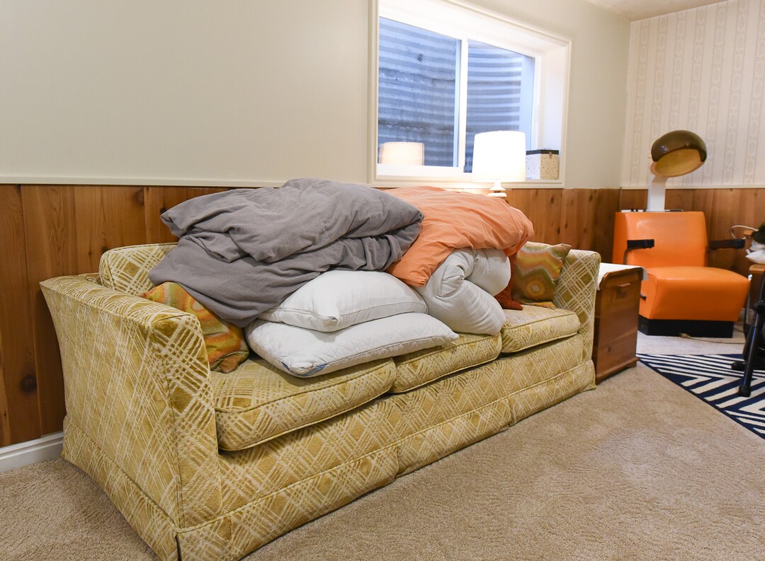 (Francisco Kjolseth  |  The Salt Lake Tribune)  Blair Tomten, who has been using the Kondo method to tidy up her home in Millcreek, holds on to a few items that she holds dear. Included is a pull out sofa, her parents first furniture purchase when they got married in Wisconsin and a hair drying chair that belonged to her grandmother, a beautician who used to run a small business out of her home. Rather than pulling linens and pillows for overflow guests when they visit, It all stays together in the basement. 