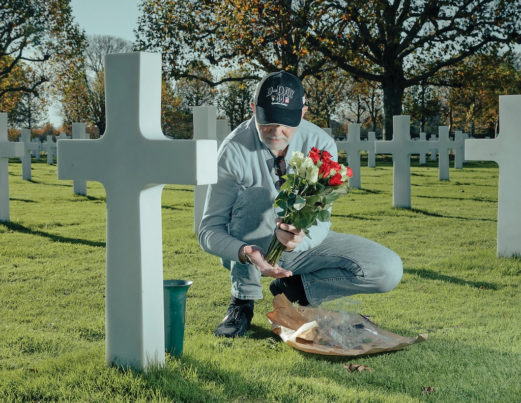 A Dutch man puts down flowers at the American Cemetery at Margraten, the Netherlands, Nov. 5, 2025. (Jan Staiger/The New York Times) 