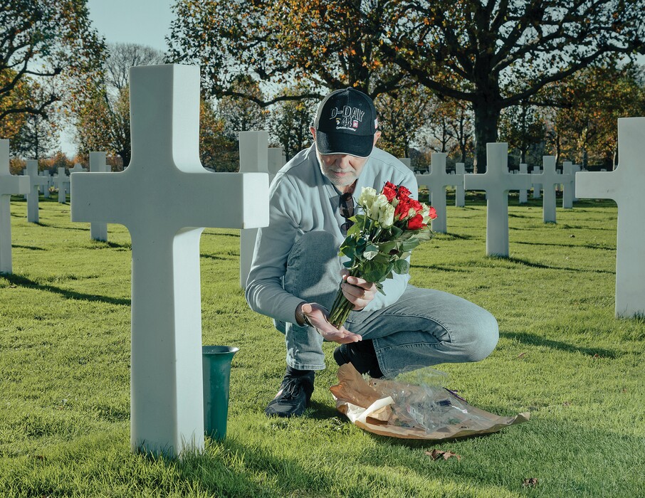 A Dutch man puts down flowers at the American Cemetery at Margraten, the Netherlands, Nov. 5, 2025. (Jan Staiger/The New York Times) 