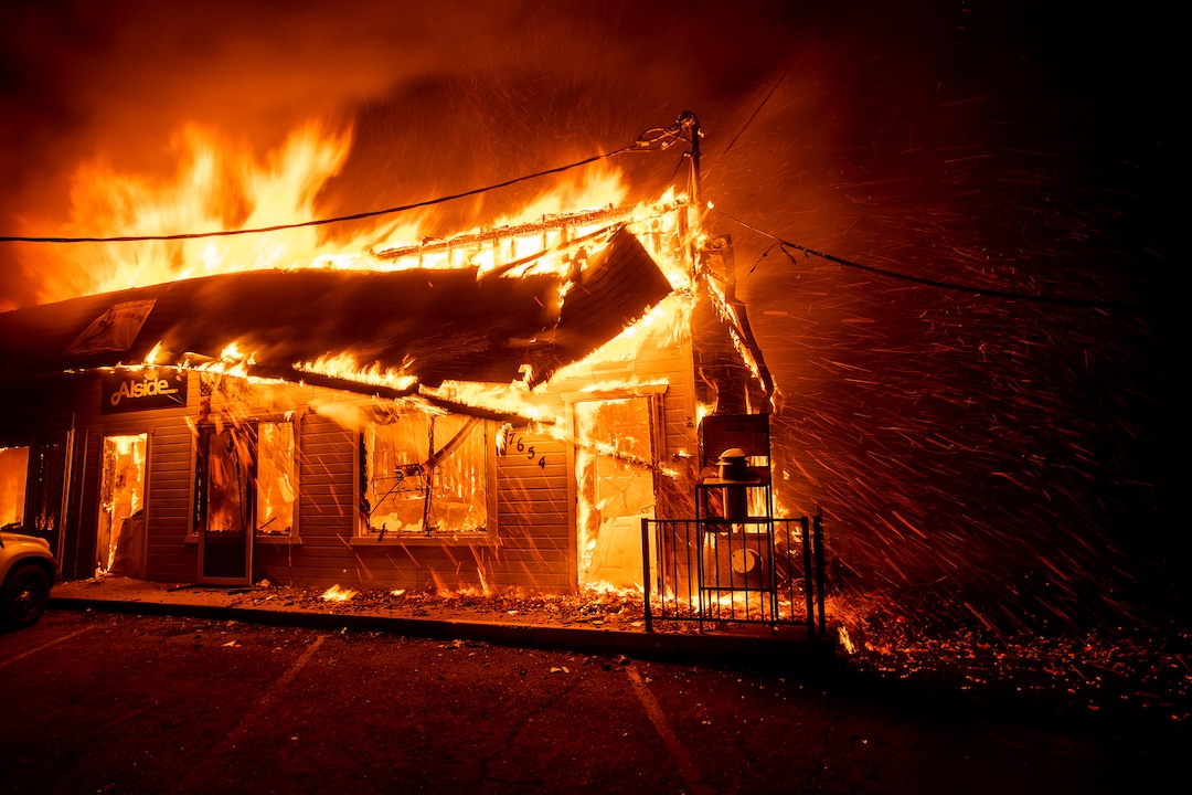 (Noah Berger | The Associated Press) Flames consume The Screen & Window Shop as the Camp Fire tears through Paradise, Calif., on Thursday, Nov. 8, 2018. Tens of thousands of people fled a fast-moving wildfire Thursday in Northern California, some clutching babies and pets as they abandoned vehicles and struck out on foot ahead of the flames that forced the evacuation of an entire town and destroyed hundreds of structures.