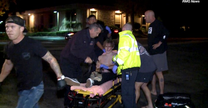In this image taken from video a victim is treated near the scene of a shooting, Wednesday evening, Nov. 7, 2018, in Thousand Oaks, Calif.  A hooded gunman dressed entirely in black opened fire on a crowd at a country dance bar holding a weekly "college night" in Southern California, killing multiple people and sending hundreds fleeing including some who used barstools to break windows and escape, authorities said Thursday. The gunman was later found dead at the scene.  (RMG News via AP)