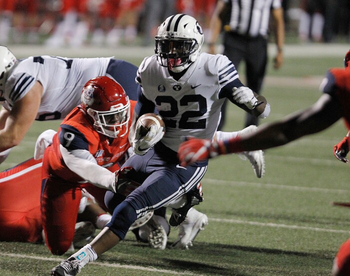BYU's running back Squally Canada runs past Fresno State's Jeffrey Allison during the second half of an NCAA college football game in Fresno, Calif., Saturday, Nov. 4, 2017. Fresno State won the game 20-13. (AP Photo/Gary Kazanjian)