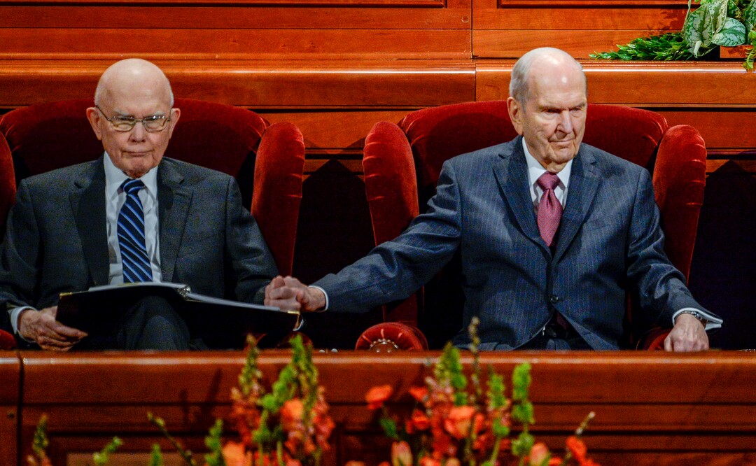 (Leah Hogsten  |  The Salt Lake Tribune) l-r President Russell M. Nelson reaches out to squeeze the hand of President Dallin H. Oaks during the morning session of the189th Annual General Conference of The Church of Jesus Christ of Latter-day Saints in Salt Lake City. President Henry B. Eyring is at right.