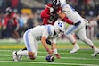 (Julio Cortez | AP) BYU quarterback Bear Bachmeier (47) recovers a bad snap in the first half of the Big 12 Conference championship game. 