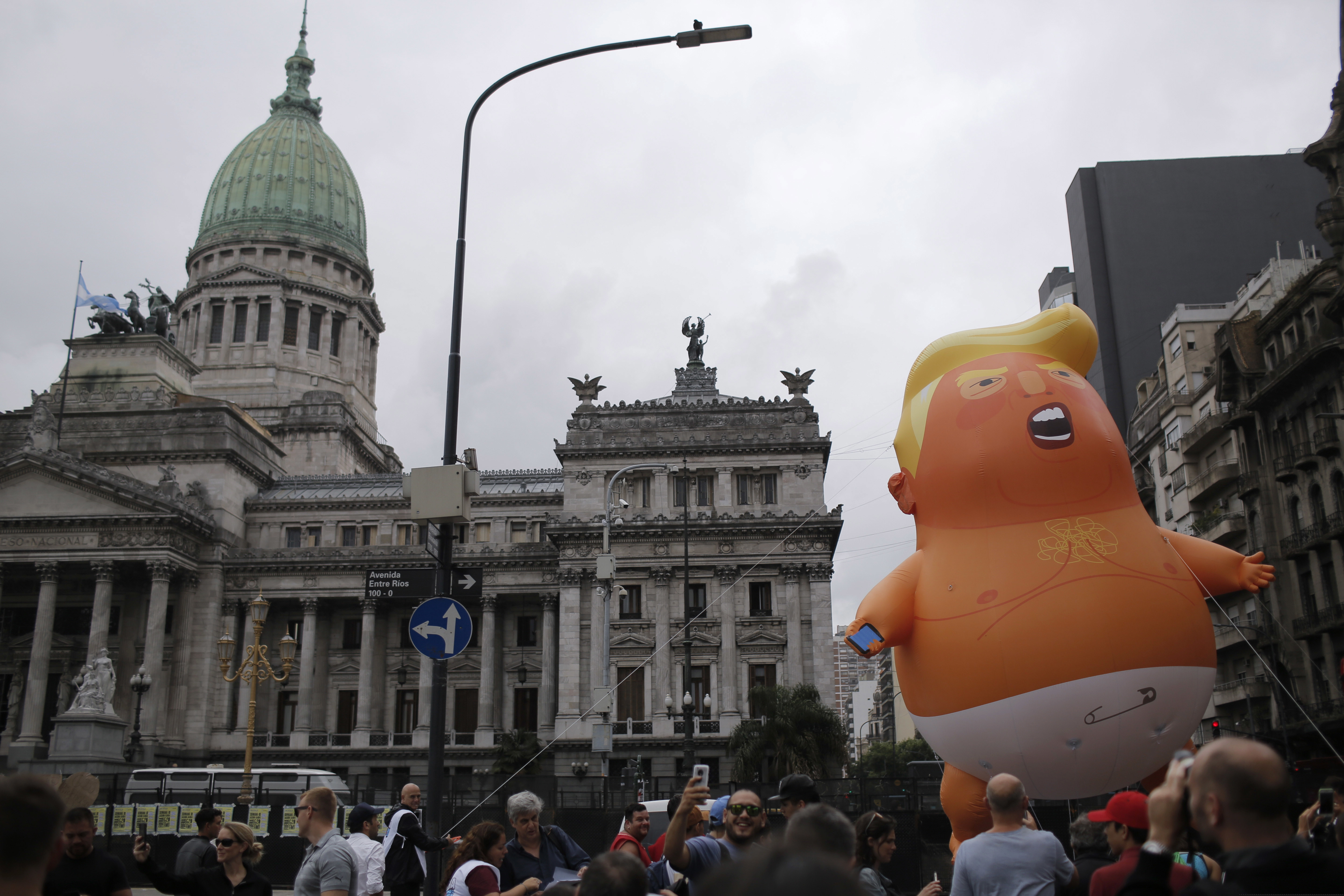 Opponents to the G20 summit carry a giant inflatable doll depicting U.S. President Donald Trump wearing a diaper in front of Congress in Buenos Aires, Argentina, Thursday, Nov. 29, 2018. Leaders from the Group of 20 industrialized nations will meet in Buenos Aires for two days starting Friday. (AP Photo/Sebastian Pani)