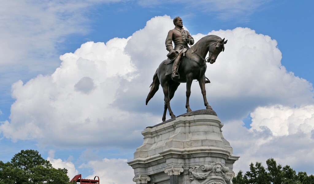 This Tuesday, June 27, 2017, photo shows the statue of Confederate Gen. Robert E. Lee that stands in the middle of a traffic circle on Monument Avenue in Richmond, Va. As cities across the United States are removing Confederate statues and other symbols, dispensing with what some see as offensive artifacts of a shameful past marked by racism and slavery, Richmond is taking a go-slow approach. (AP Photo/Steve Helber)