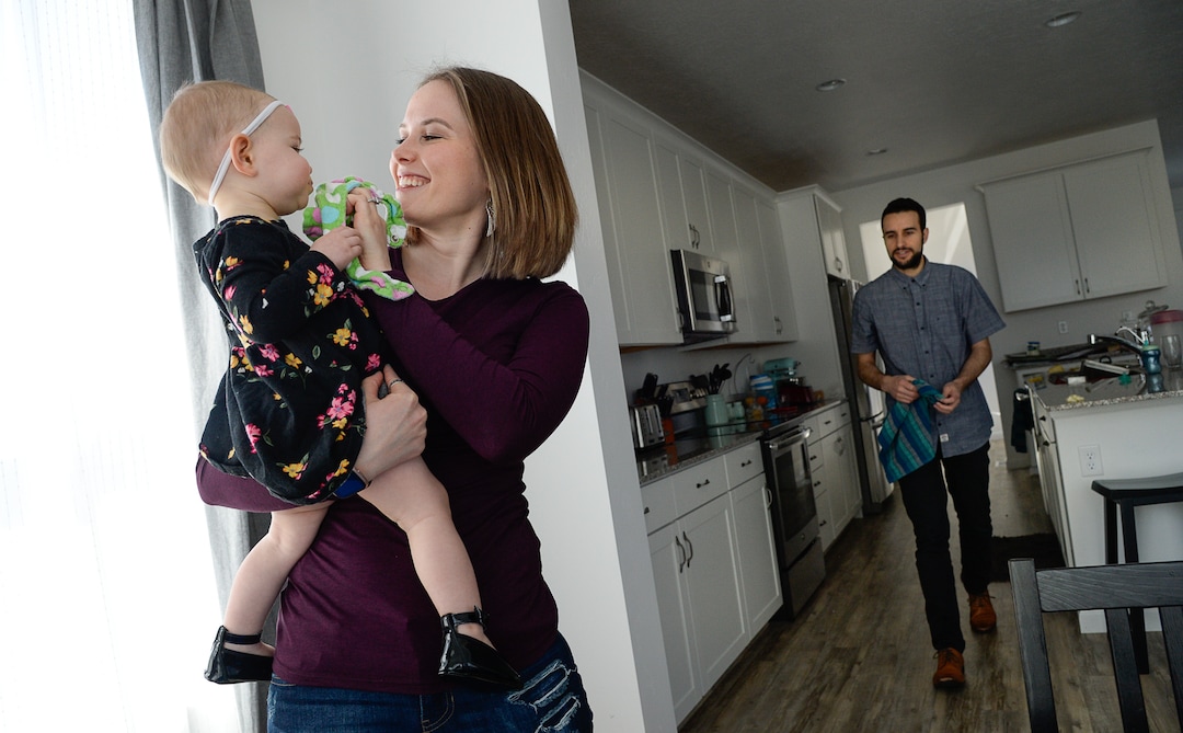(Francisco Kjolseth  |  The Salt Lake Tribune)  Ember and Jeremy Ulrich spend time with their daughter Jemma, 1, at their home in Lehi after moving from Pleasant Grove last October because they could get more house for their money there, and it's closer to Jeremy's job at Adobe in Lehi.